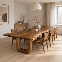 Live edge dining table on two thick u shaped legs in a Scandinavian dining room with white walls