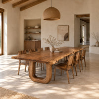 Live edge dining table on two thick u shaped legs in a bright open plan dining room