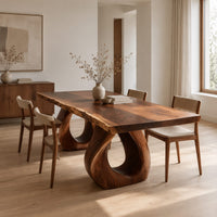 Rectangular dining table with a live edge slab top and two loop pedestals in a Scandinavian dining room with white walls