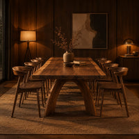 Live edge dining table with a thick slab top and two arched legs in an evening dining room with walnut wall paneling