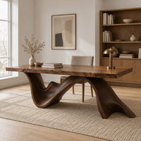 Live edge desk with a dark sculpted wave shaped base in a Scandinavian home office with white walls