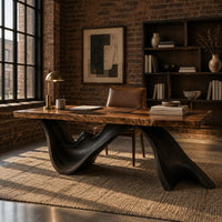 Live edge desk with a dark sculpted wave shaped base in an industrial loft home office with exposed brick