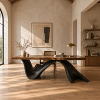 Live edge desk with a dark sculpted wave shaped base in a bright open plan home office