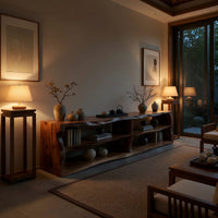 Live edge TV cabinet with open shelves in an evening room lit by two lamps