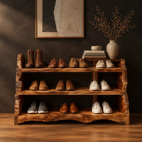 Open shoe shelf with three tiers and natural live edge sides in a dark studio against a charcoal plaster wall