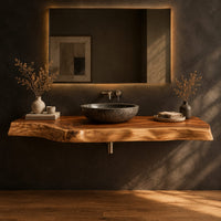 Thick live edge wood slab with natural wavy edge and open space below in a dark studio against a charcoal plaster wall
