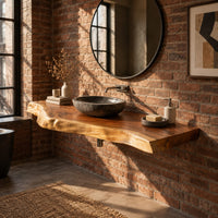Thick live edge wood slab with natural wavy edge and open space below in an industrial loft bathroom with exposed brick