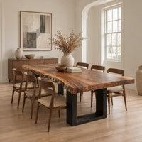 Live edge slab dining table on two dark squared frame legs in a Scandinavian dining room with white walls