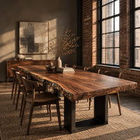 Live edge slab dining table on two dark squared frame legs in an industrial loft dining room with exposed brick