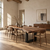 Live edge slab dining table on two dark squared frame legs in a bright open plan dining room