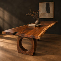 Long live edge slab dining table on thick ring shaped bases, three-quarter view showing the grain