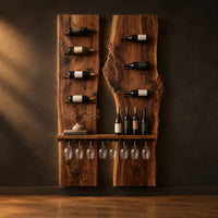 Two tall wood slab panels with slim dark pegs and a shelf for glasses in a dark studio against a charcoal plaster wall