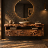 Wall hung cabinet with live edge top, open shelf and wave carved front in a dark bathroom at golden hour