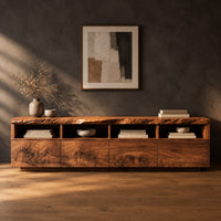 Live edge tv stand with four open cubbies above swirling grain front panels in a dark studio against a charcoal plaster wall