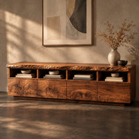 Corner detail of live edge tv stand with four open cubbies above swirling grain front panels beside wood, brass and linen samples