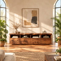Live edge tv stand with four open cubbies above swirling grain front panels in a bright living room with arched windows and plants