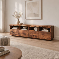 Live edge tv stand with four open cubbies above swirling grain front panels in a Scandinavian living room with white walls