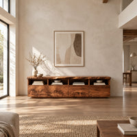 Live edge tv stand with four open cubbies above swirling grain front panels in a bright open plan living room