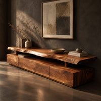 Long low tv stand with a natural edge slab top over a block base, three-quarter view showing the grain