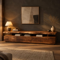 Long low tv stand with a natural edge slab top over a block base in a dark living room at golden hour