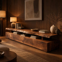 Long low tv stand with a natural edge slab top over a block base in an evening living room with walnut wall paneling