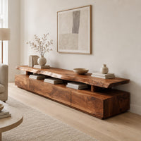 Long low tv stand with a natural edge slab top over a block base in a Scandinavian living room with white walls
