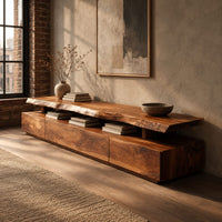 Long low tv stand with a natural edge slab top over a block base in an industrial loft living room with exposed brick
