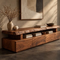 Corner detail of live edge tv stand with a raised slab top and an open display gap beside wood, brass and linen samples