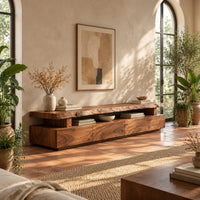 Live edge tv stand with a raised slab top and an open display gap in a bright living room with arched windows and plants