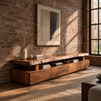 Live edge tv stand with a raised slab top and an open display gap in an industrial loft living room with exposed brick