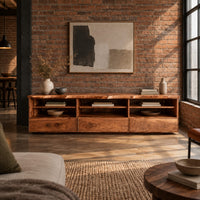 Live edge tv stand with three open shelf bays and lower front panels in an industrial loft living room with exposed brick