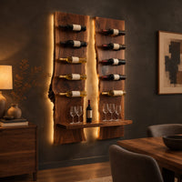 Wine rack of two tall live edge slabs with angled bottle pegs in a dark dining room at golden hour
