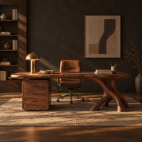 Desk with a long soft cornered top, three drawer block and branch leg in a dark home office at golden hour