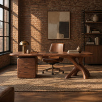 Desk with a long soft cornered top, three drawer block and branch leg in an industrial loft home office with exposed brick