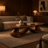 Long oval coffee table on a flowing wave shaped wooden pedestal base in an evening living room with walnut wall paneling