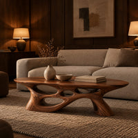 Long oval coffee table with a sweeping cutout base in an evening living room with walnut wall paneling