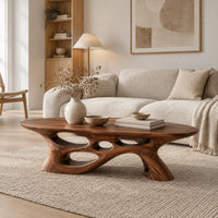Long oval coffee table with a sweeping cutout base in a Scandinavian living room with white walls