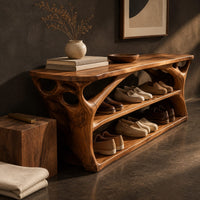 Corner detail of long low shoe bench with open shelves and branching sculpted sides beside wood, brass and linen samples