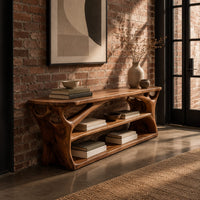 Long low shoe bench with open shelves and branching sculpted sides in an industrial loft entryway with exposed brick