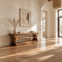 Long low shoe bench with open shelves and branching sculpted sides in a bright open plan entryway
