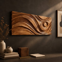 Detail of long horizontal wall panel carved with sweeping waves and a raised disc beside wood, brass and linen samples