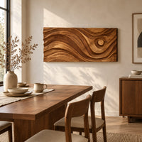 Long horizontal wall panel carved with sweeping waves and a raised disc beside a dining table in natural light