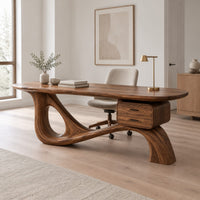 Desk with an oval top, a looped sculpted base and a two drawer box in a Scandinavian home office with white walls