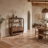 Bar cabinet with a looped wood frame, open shelf and slotted base in a bright open plan dining room