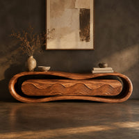Corner detail of loop framed tv stand with a ripple carved four panel front beside wood, brass and linen samples