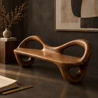 Corner detail of bench with a flat plank seat, looped arms and ring shaped legs beside wood, brass and linen samples