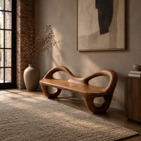 Bench with a flat plank seat, looped arms and ring shaped legs in an industrial loft entryway with exposed brick