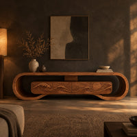 Tv stand inside a looped wooden frame with an ocean wave carved front in a dark living room at golden hour