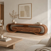Tv stand inside a looped wooden frame with an ocean wave carved front in a Scandinavian living room with white walls