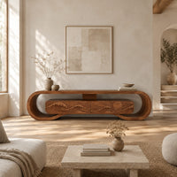 Tv stand inside a looped wooden frame with an ocean wave carved front in a bright open plan living room